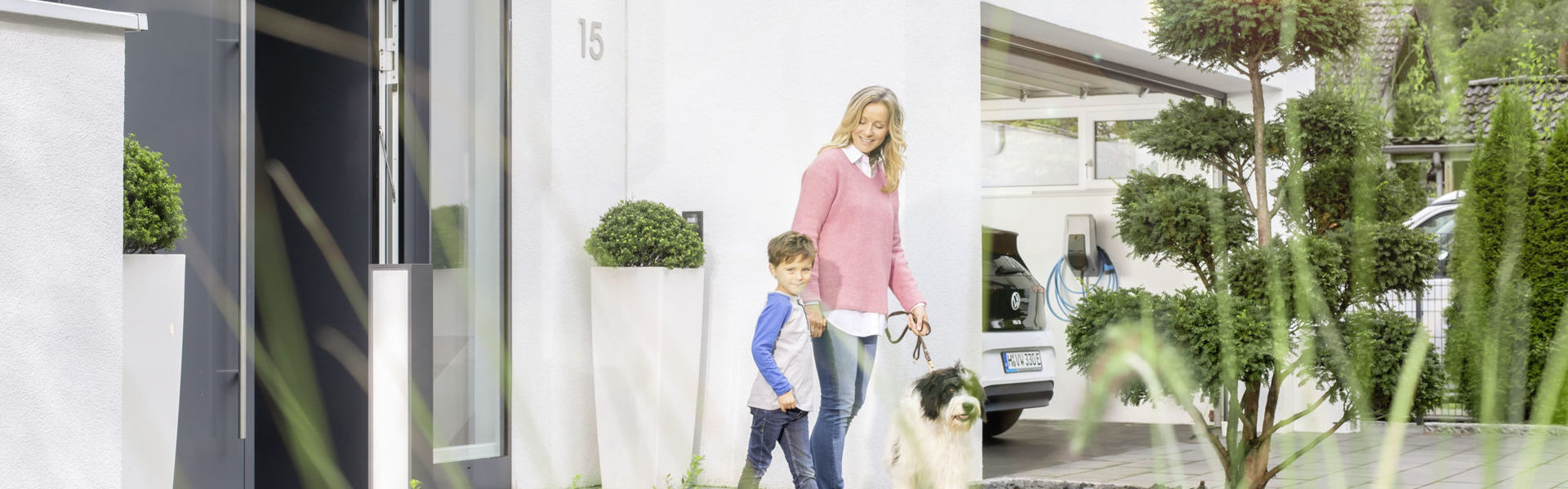 Familie mit Hund und MENNEKES Wallbox in Garage